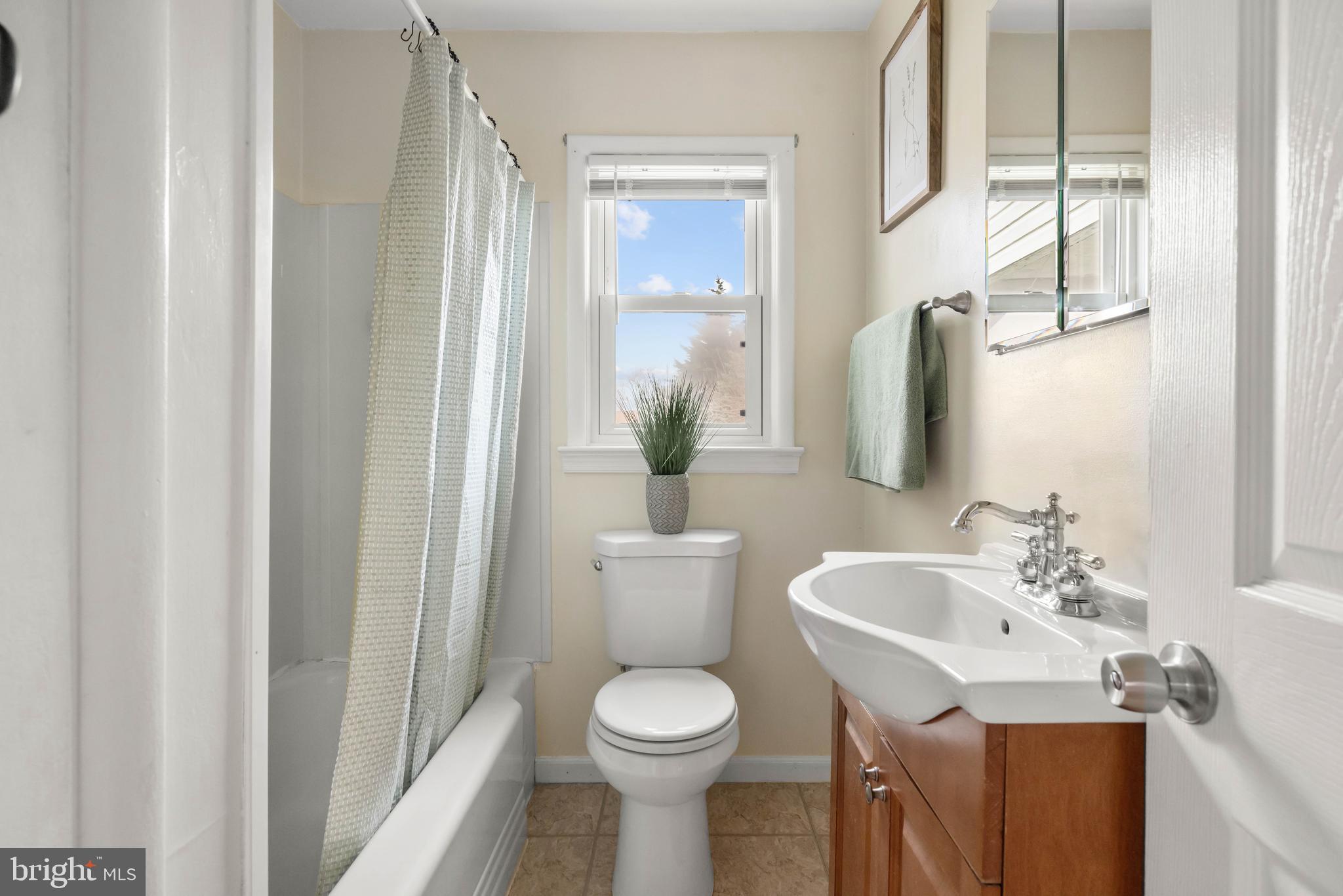 405 East 7th Avenue Ranson, WV 25438 - Photo 13 of 26 a bathroom with a toilet sink and mirror