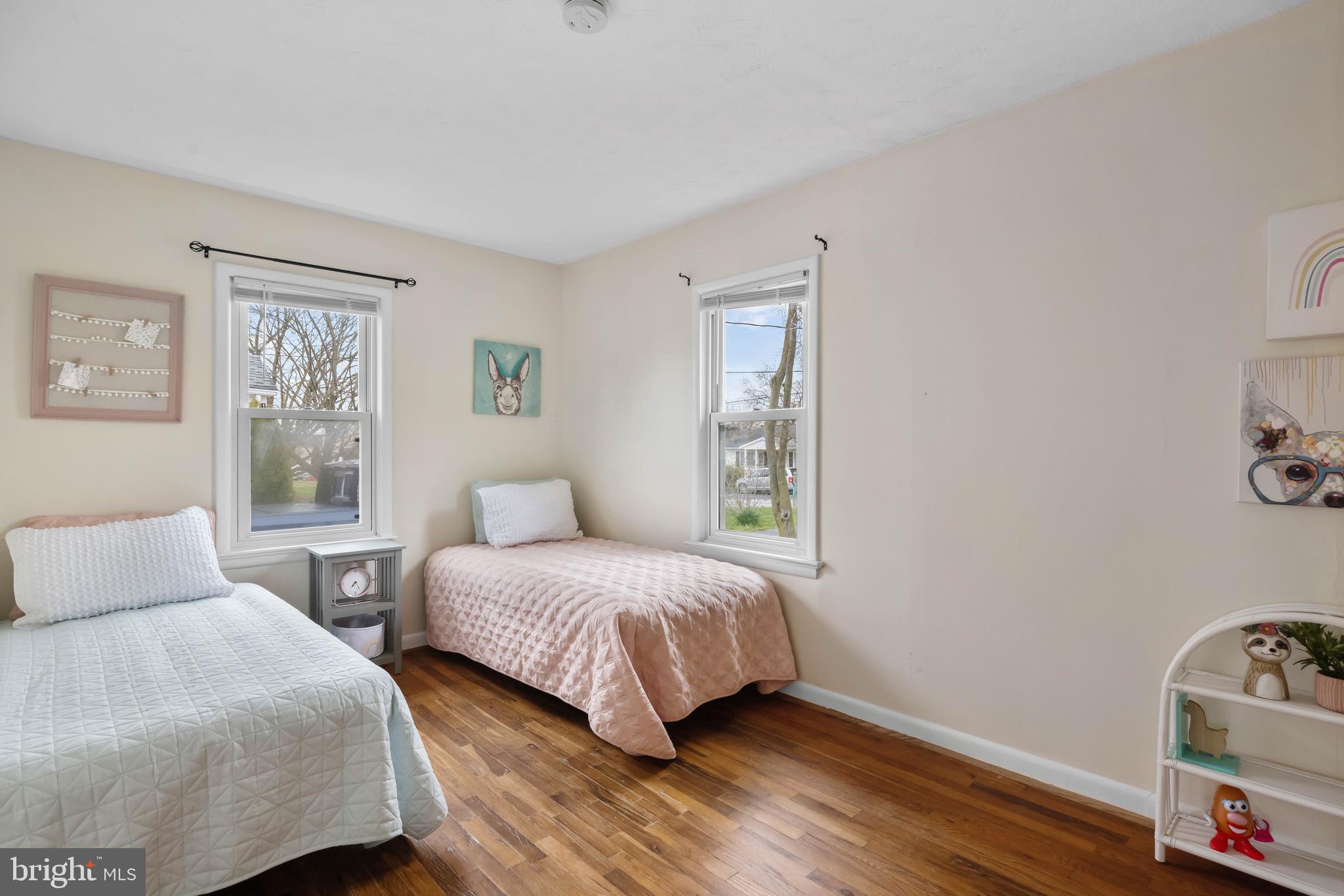 405 East 7th Avenue Ranson, WV 25438 - Photo 14 of 26 a bedroom with two beds and wooden floor