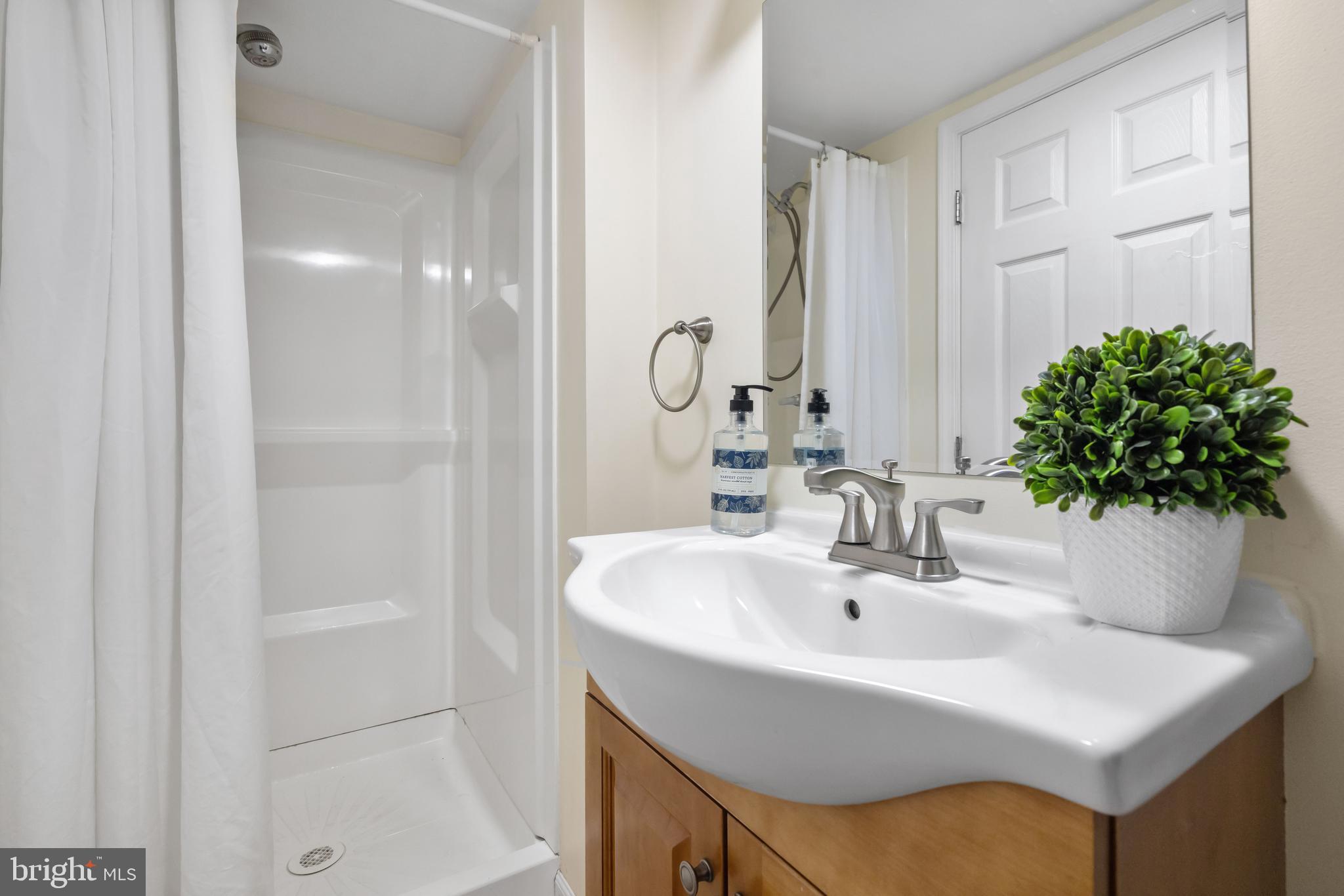 405 East 7th Avenue Ranson, WV 25438 - Photo 15 of 26 a bathroom with a sink and a mirror