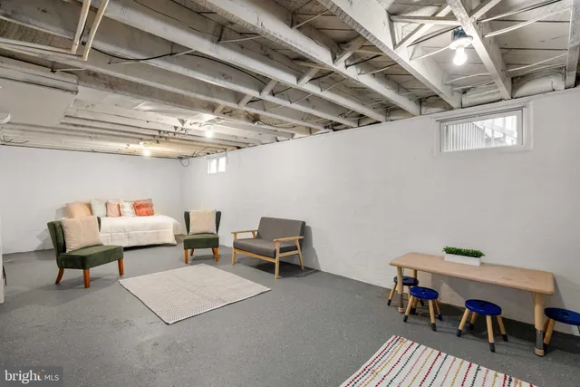 a reading room with furniture and a chandelier