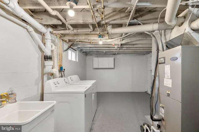 a utility room with a sink dryer and washer