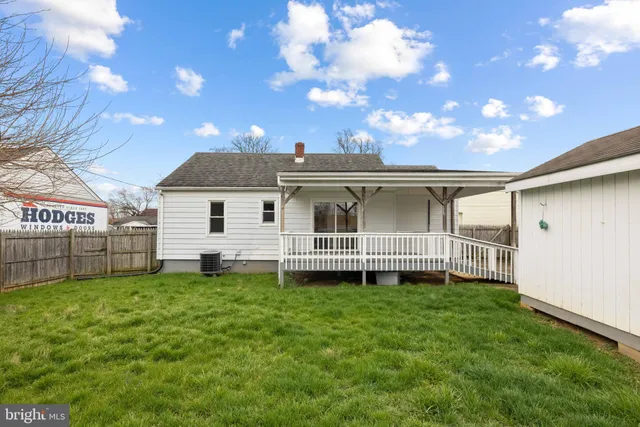 a view of a house with a yard and sitting area
