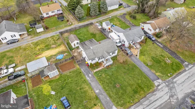 an aerial view of a house with a garden and lake view