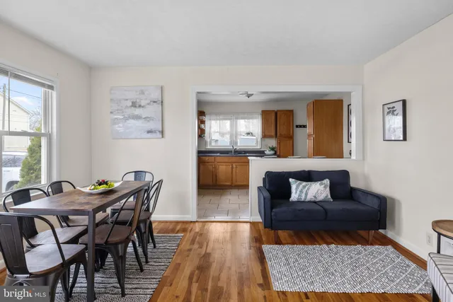 a living room with a couch and a wooden floor