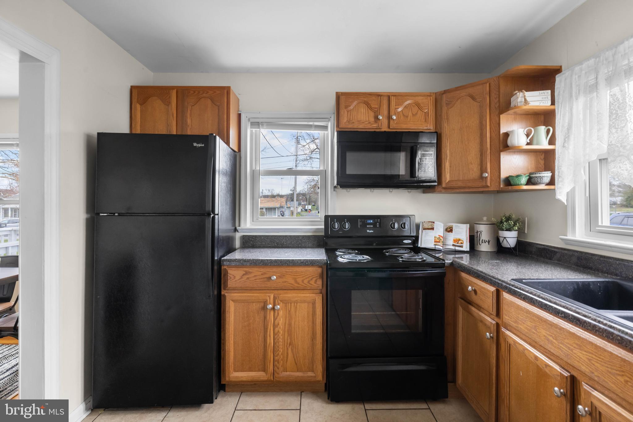405 East 7th Avenue Ranson, WV 25438 - Photo 6 of 26 a kitchen with a refrigerator and a sink
