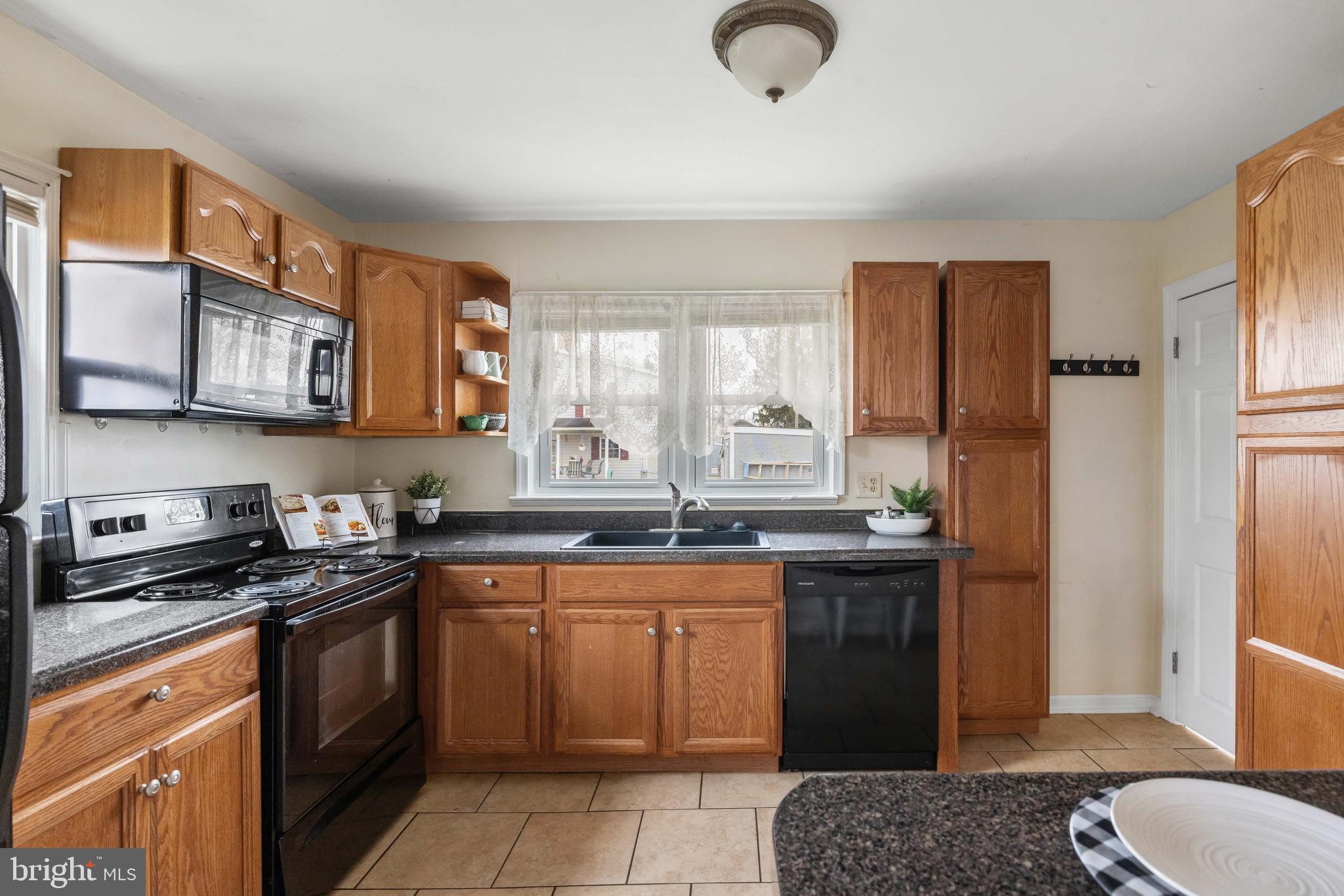 405 East 7th Avenue Ranson, WV 25438 - Photo 7 of 26 a kitchen with stainless steel appliances granite countertop a stove a sink dishwasher and a refrigerator