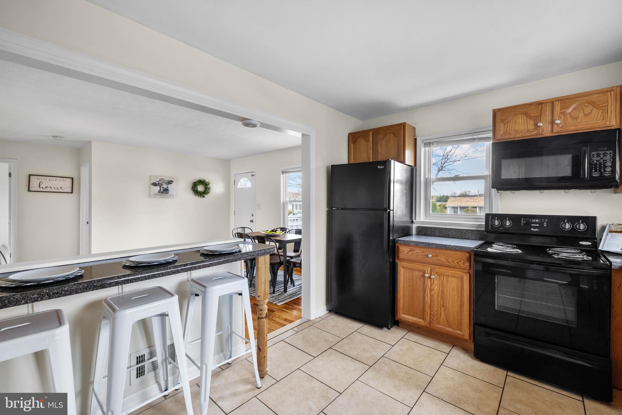 405 East 7th Avenue Ranson, WV 25438 - Photo 8 of 26 a kitchen with granite countertop a refrigerator stove and microwave