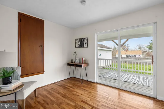 a bedroom with a balcony a bed and a chair