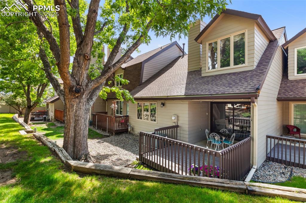 4835 Castledown Road Colorado Springs, CO 80917 - Photo 1 of 29 a front view of a house with garden and porch
