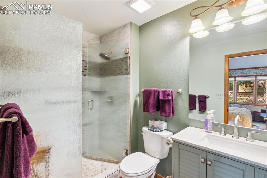 4835 Castledown Road Colorado Springs, CO 80917 - Photo 13 of 29 a bathroom with a sink vanity mirror and toilet