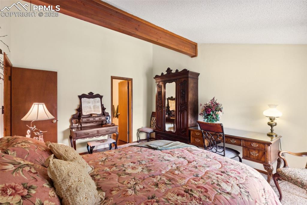 4835 Castledown Road Colorado Springs, CO 80917 - Photo 15 of 29 a bedroom with a bed and a dresser with mirror