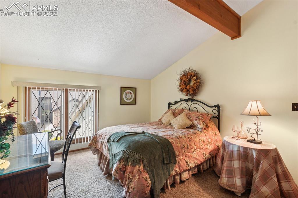 4835 Castledown Road Colorado Springs, CO 80917 - Photo 16 of 29 a bedroom with a bed and wooden floor