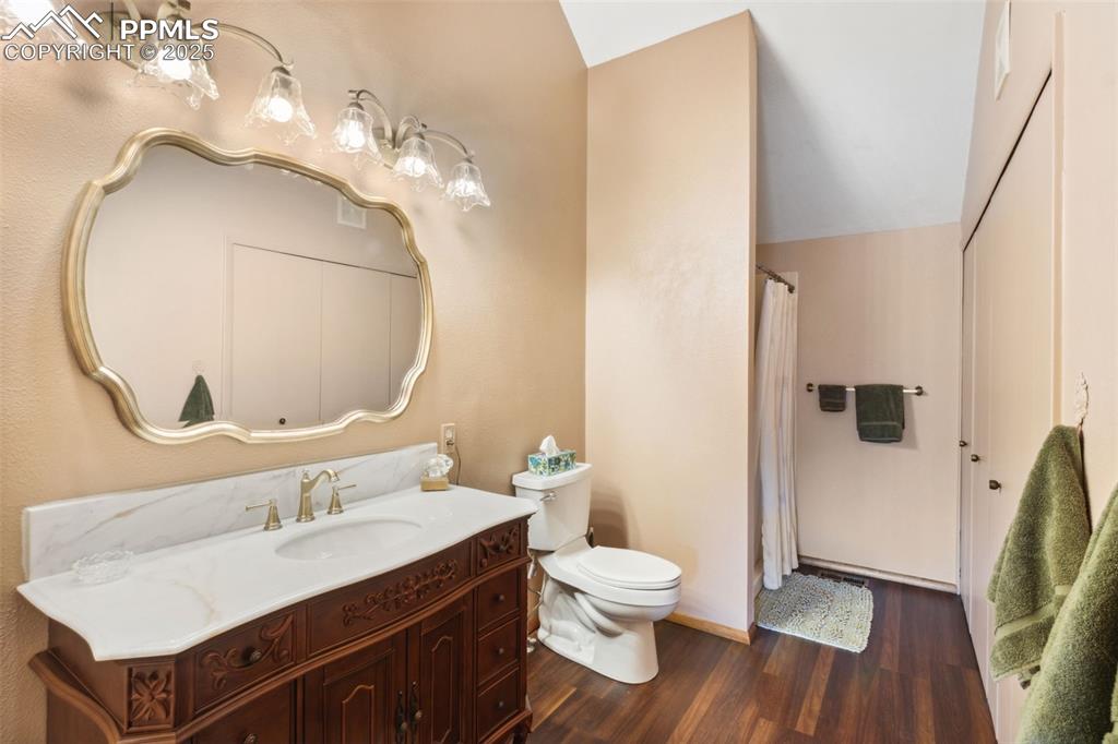 4835 Castledown Road Colorado Springs, CO 80917 - Photo 17 of 29 a bathroom with a sink a toilet and a mirror
