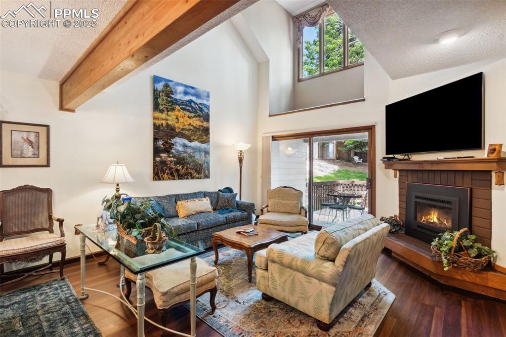 4835 Castledown Road Colorado Springs, CO 80917 - Photo 2 of 29 a living room with furniture a flat screen tv and a fireplace