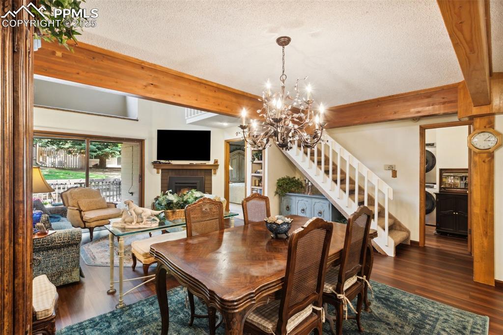 4835 Castledown Road Colorado Springs, CO 80917 - Photo 4 of 29 a dining room with furniture a chandelier and wooden floor