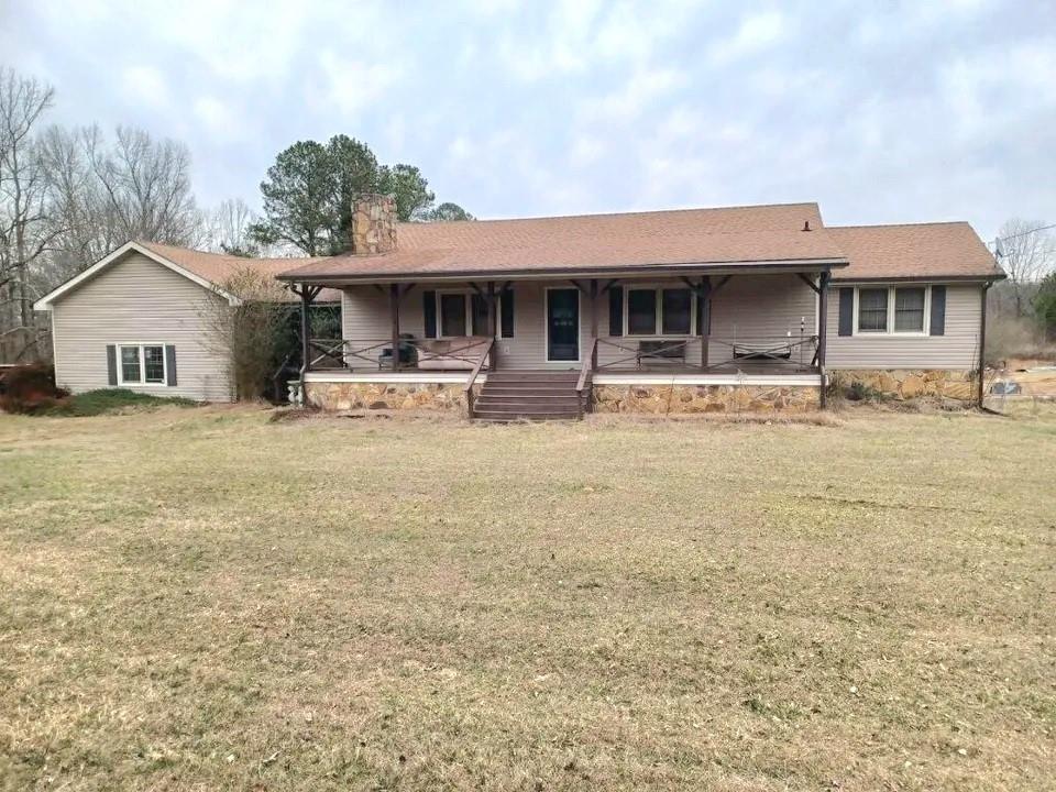 6872 Heardsville Road Cumming, GA 30028 - Photo 1 of 1 a front view of a house with a yard and garage