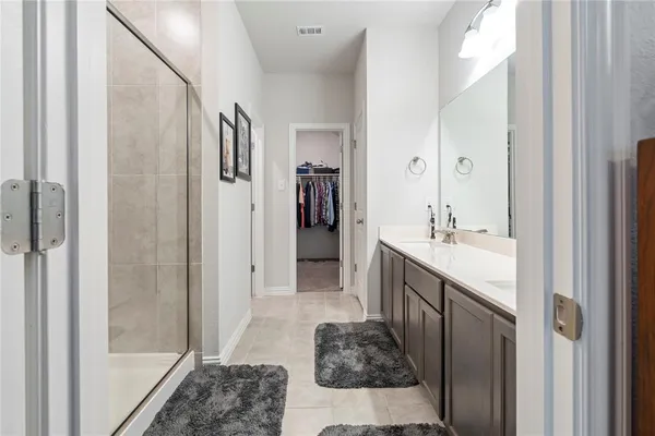 a spacious bathroom with a tub shower and sink
