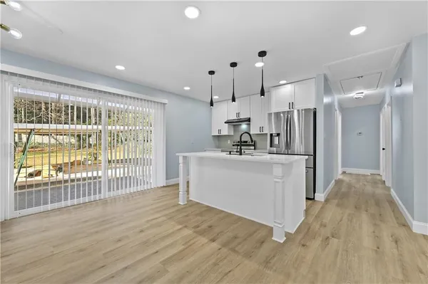 a view of a kitchen with a sink and refrigerator