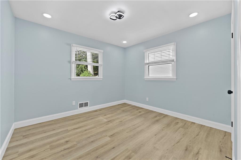 1728 Wayland Circle Northeast Brookhaven, GA 30319 - Photo 22 of 31 wooden floor in an empty room with a window