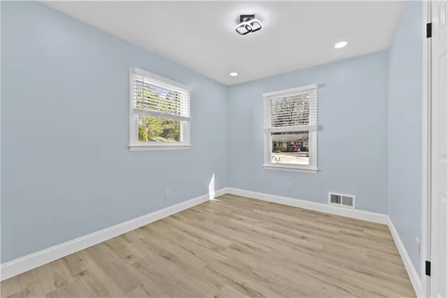 a view of room with window and wooden floor