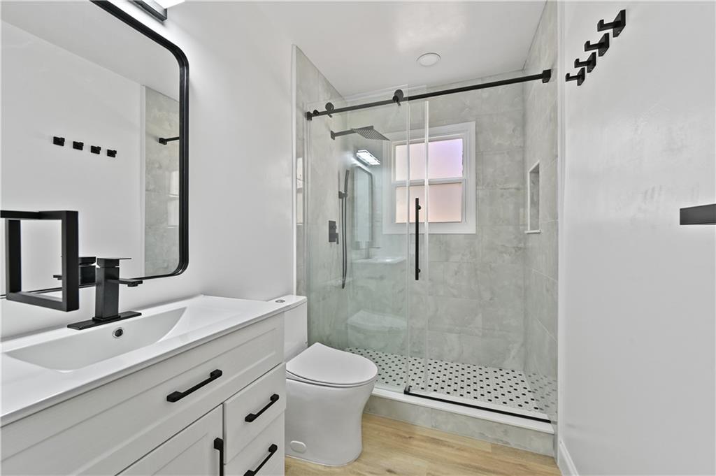 1728 Wayland Circle Northeast Brookhaven, GA 30319 - Photo 26 of 31 a bathroom with a shower sink vanity mirror and toilet