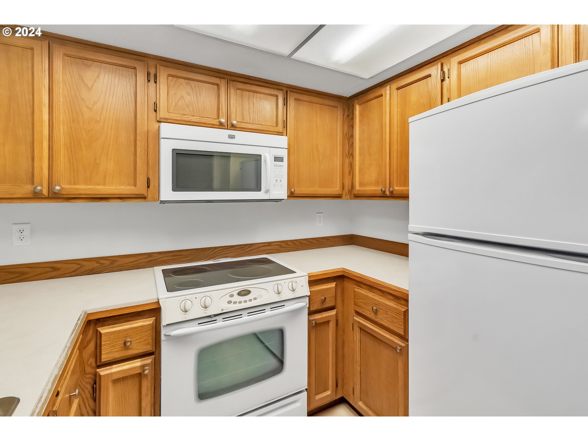 2051 Lake Isle Terrace Eugene, OR 97401 - Photo 17 of 36 a kitchen with a refrigerator sink and cabinets