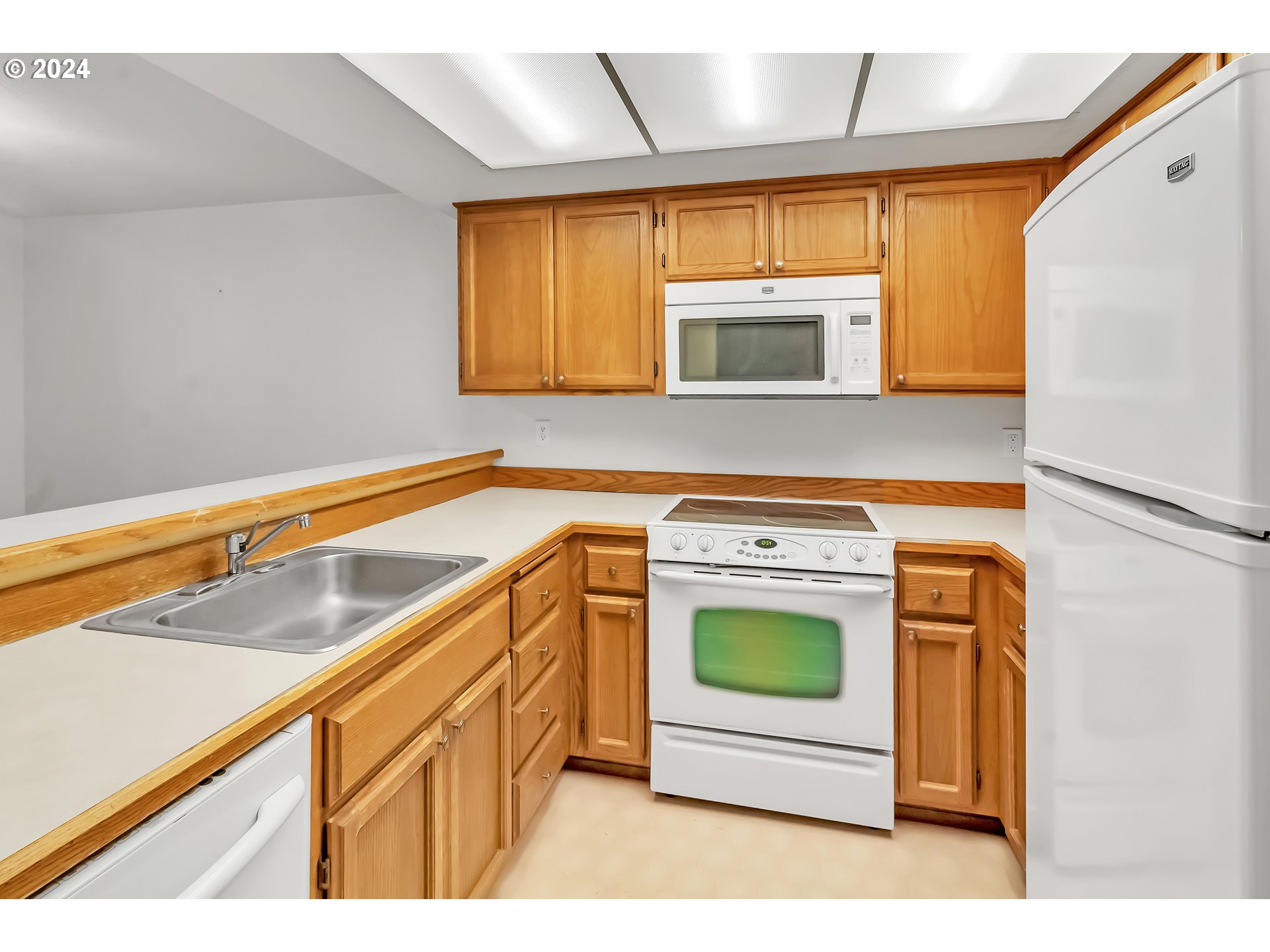 2051 Lake Isle Terrace Eugene, OR 97401 - Photo 18 of 36 a kitchen with stainless steel appliances granite countertop a stove a sink and a microwave
