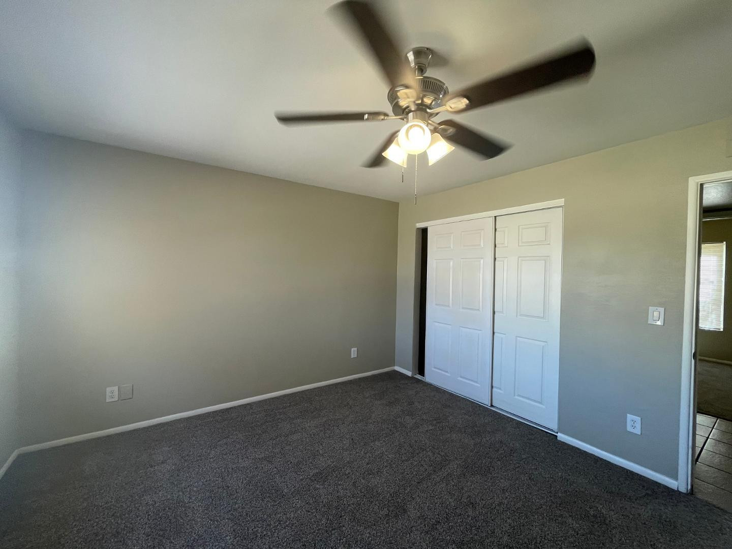 10902 West Montecito Avenue Phoenix, AZ 85037 - Photo 13 of 22 an empty room with a fan and a fan