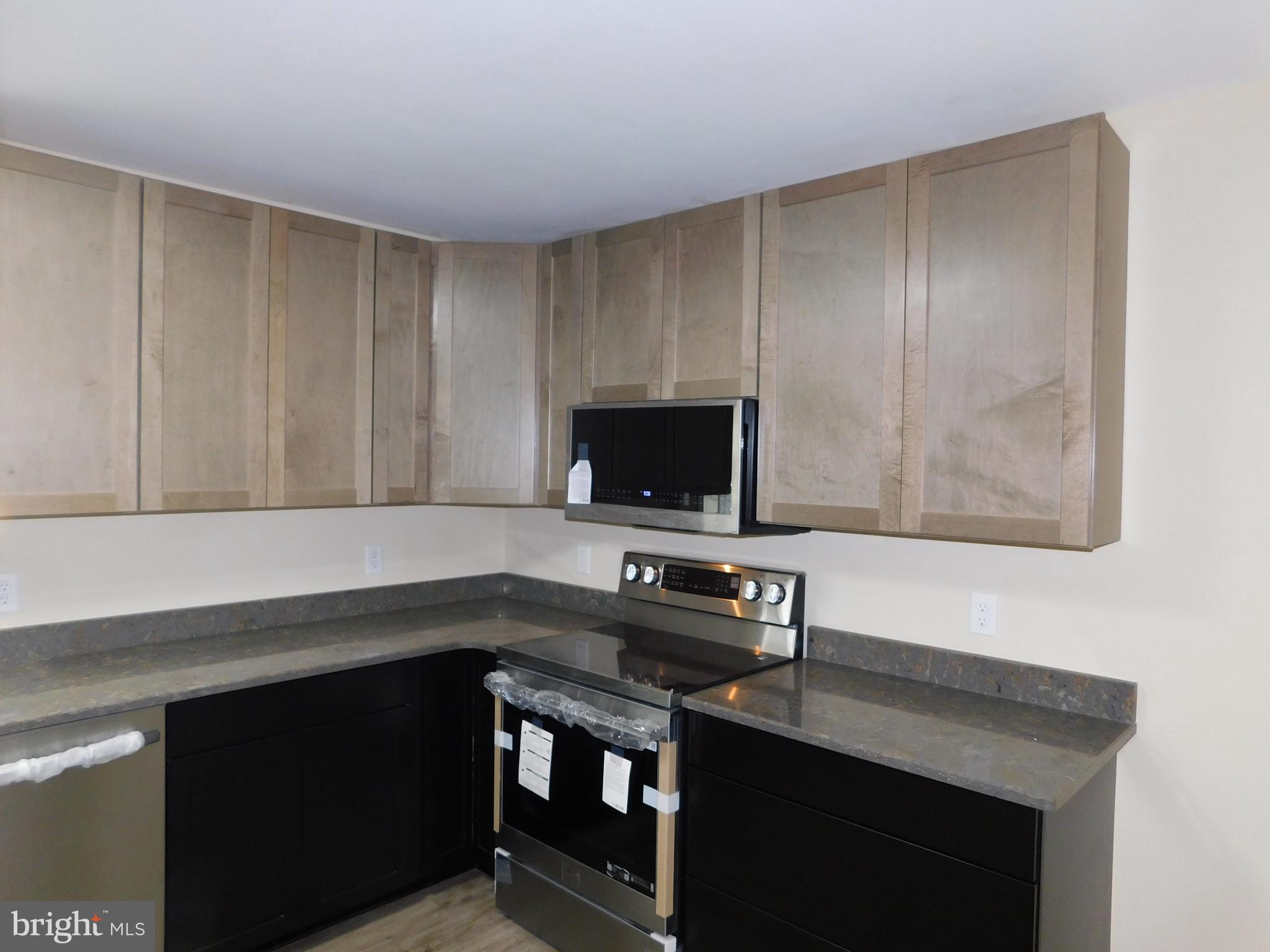233 Hartly Road Hartly, DE 19953 - Photo 15 of 70 a kitchen with a sink cabinets and a microwave