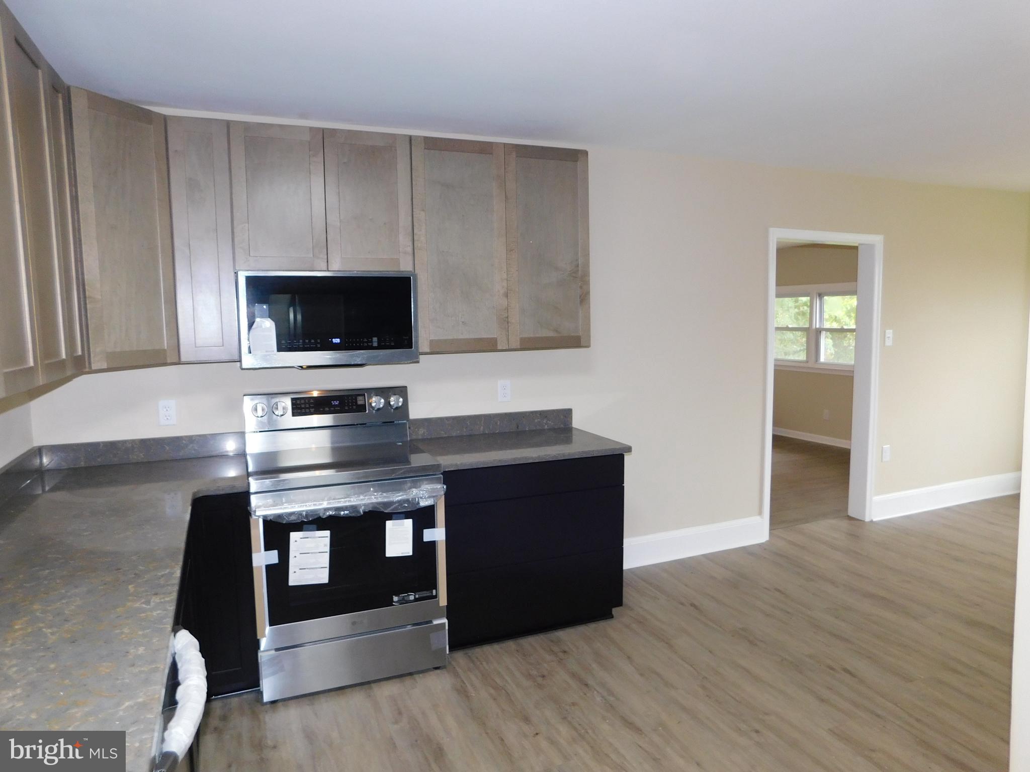 233 Hartly Road Hartly, DE 19953 - Photo 16 of 70 a kitchen with a stove and a microwave