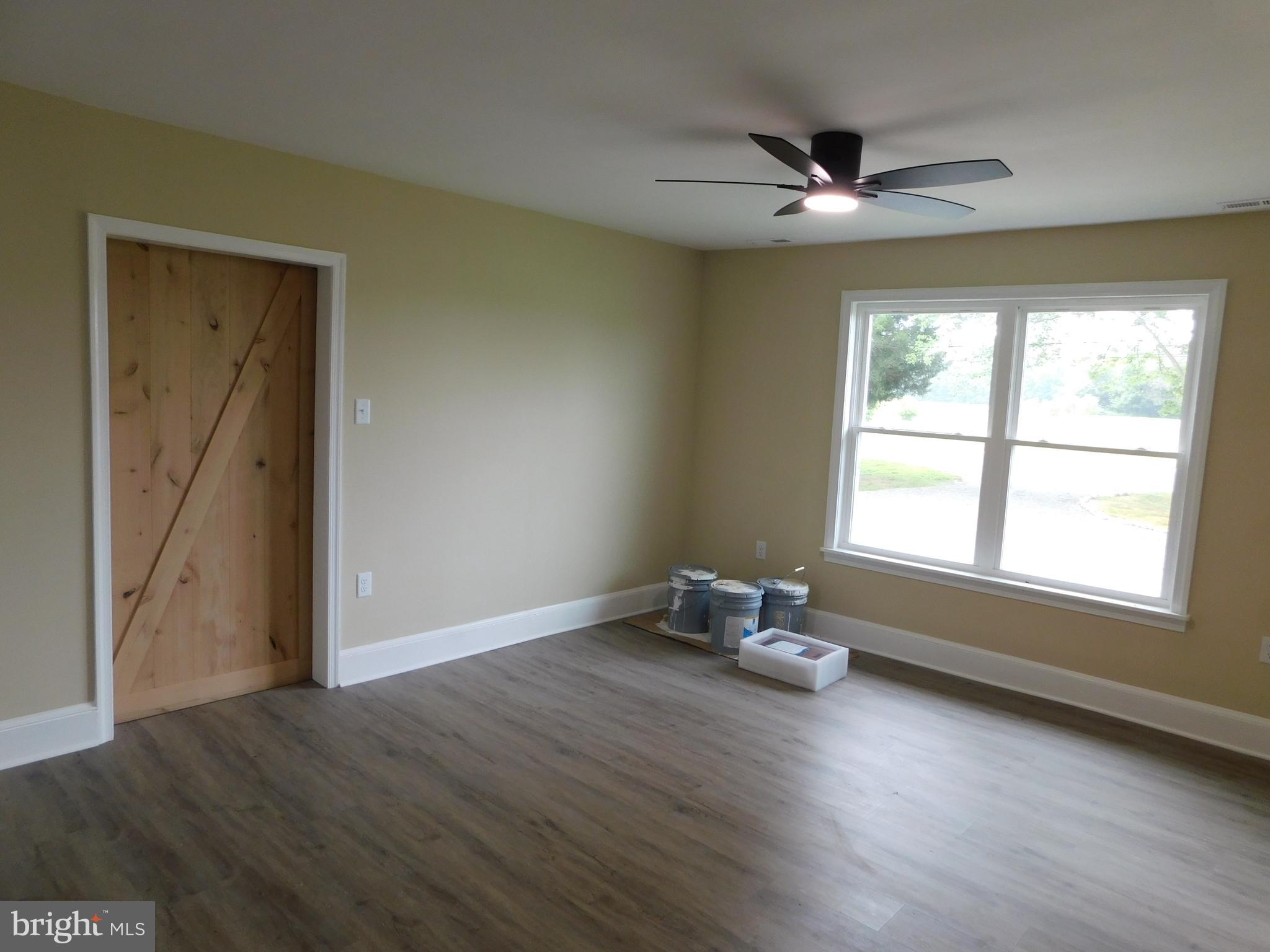233 Hartly Road Hartly, DE 19953 - Photo 21 of 70 an empty room with wooden floor and windows