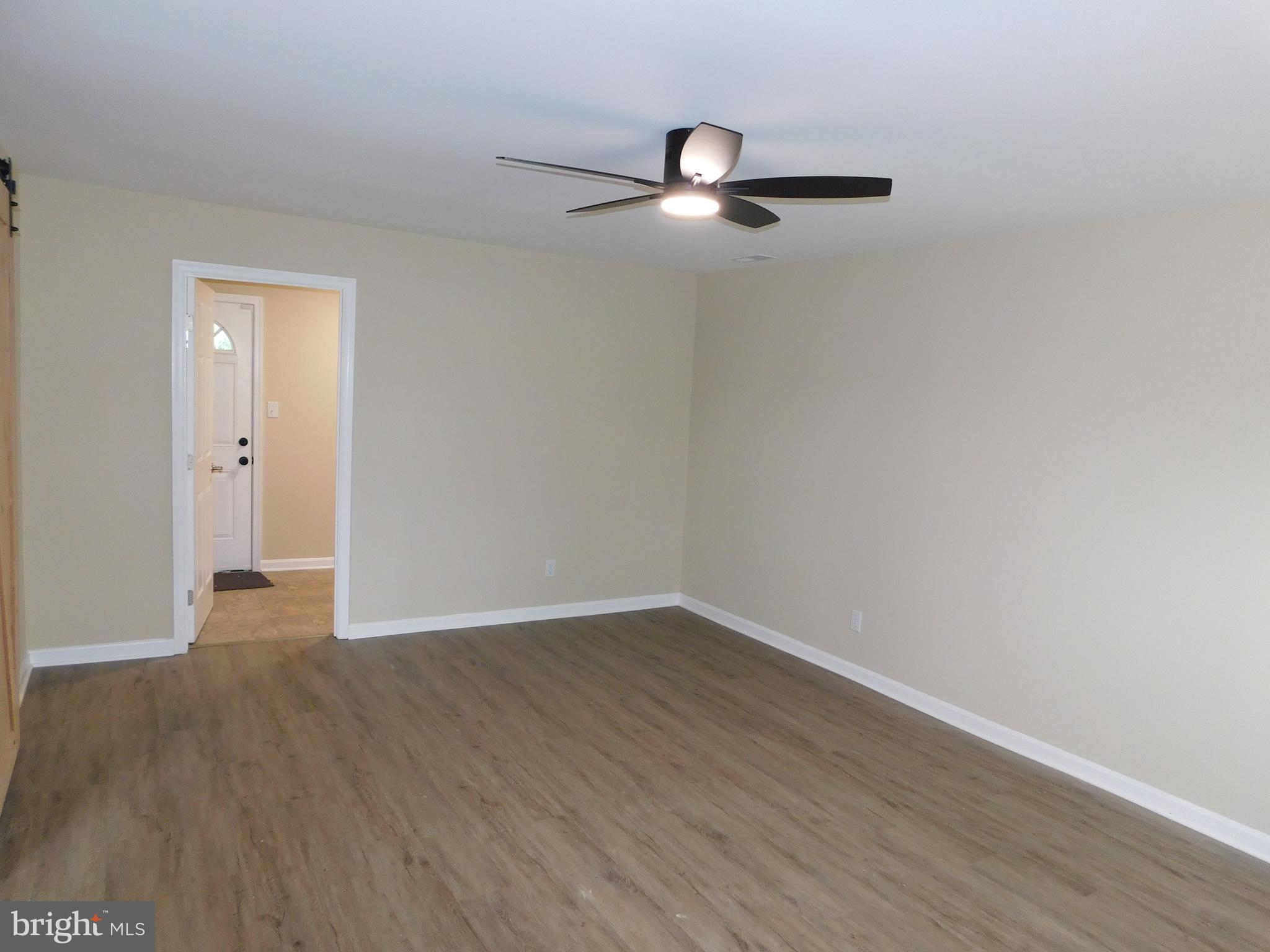 233 Hartly Road Hartly, DE 19953 - Photo 24 of 70 an empty room with wooden floor closet and windows
