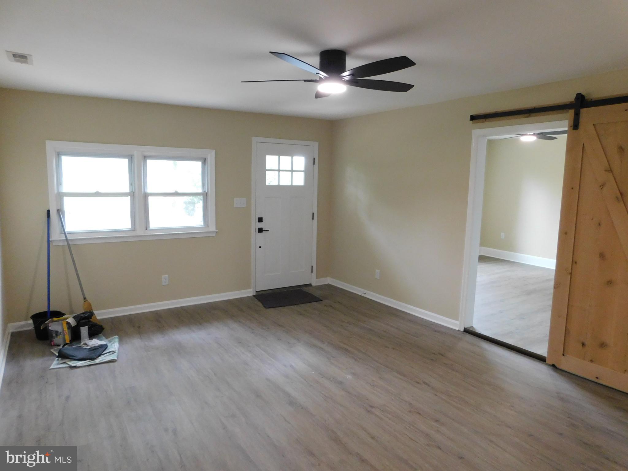 233 Hartly Road Hartly, DE 19953 - Photo 26 of 70 an empty room with wooden floor and windows