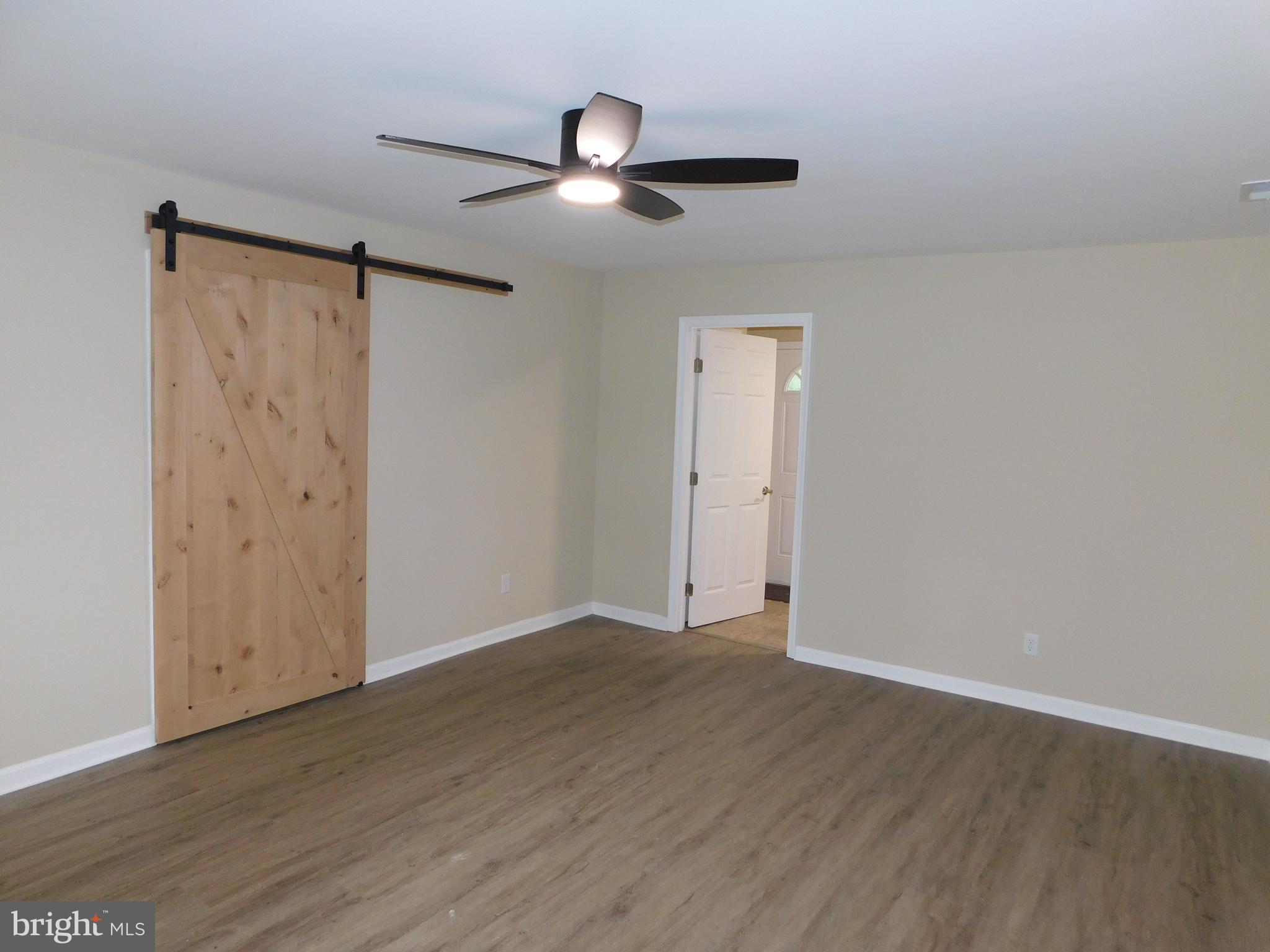 233 Hartly Road Hartly, DE 19953 - Photo 29 of 70 an empty room with wooden floor cabinet and windows