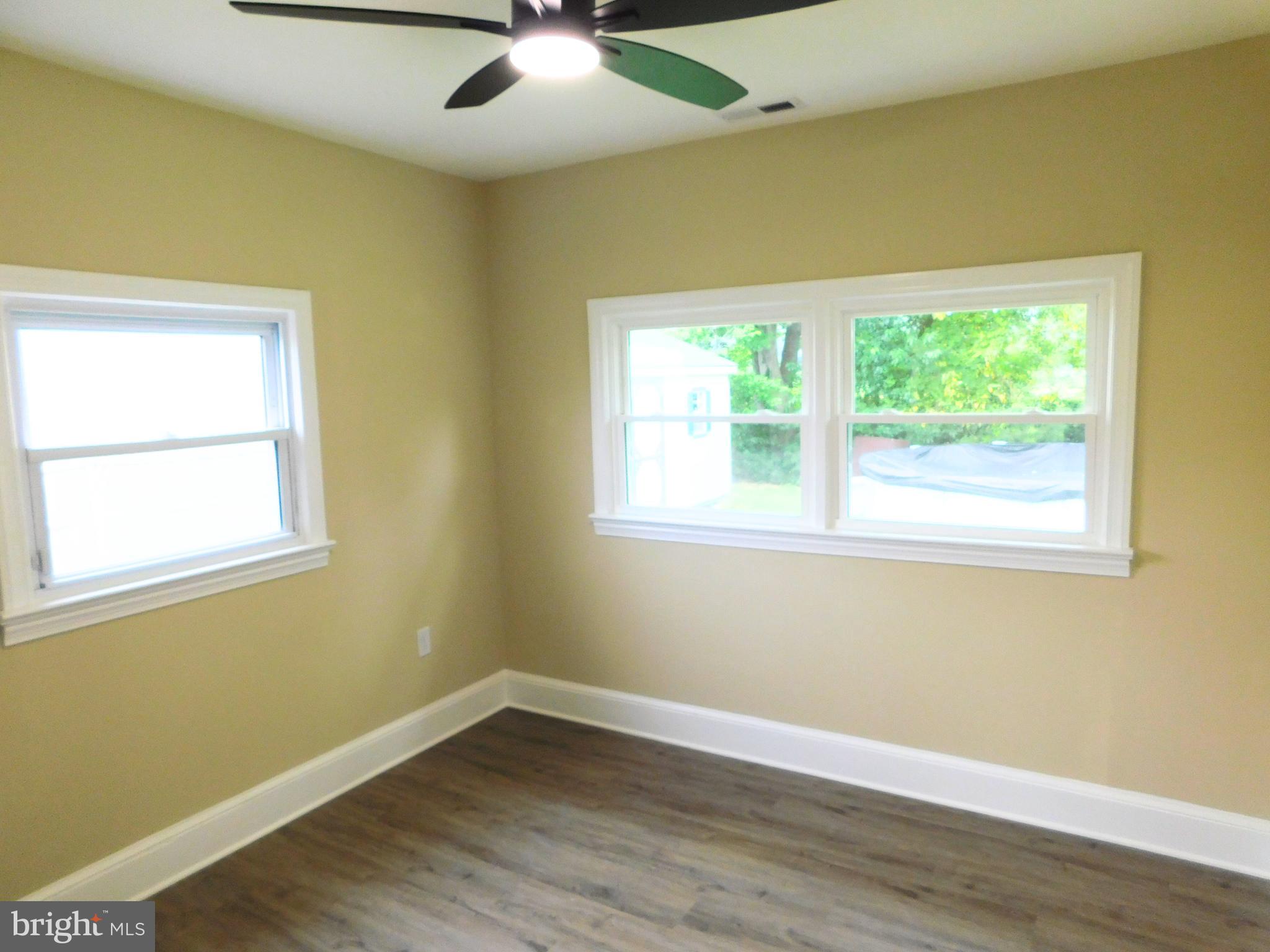 233 Hartly Road Hartly, DE 19953 - Photo 35 of 70 a view of an empty room with wooden floor and a window