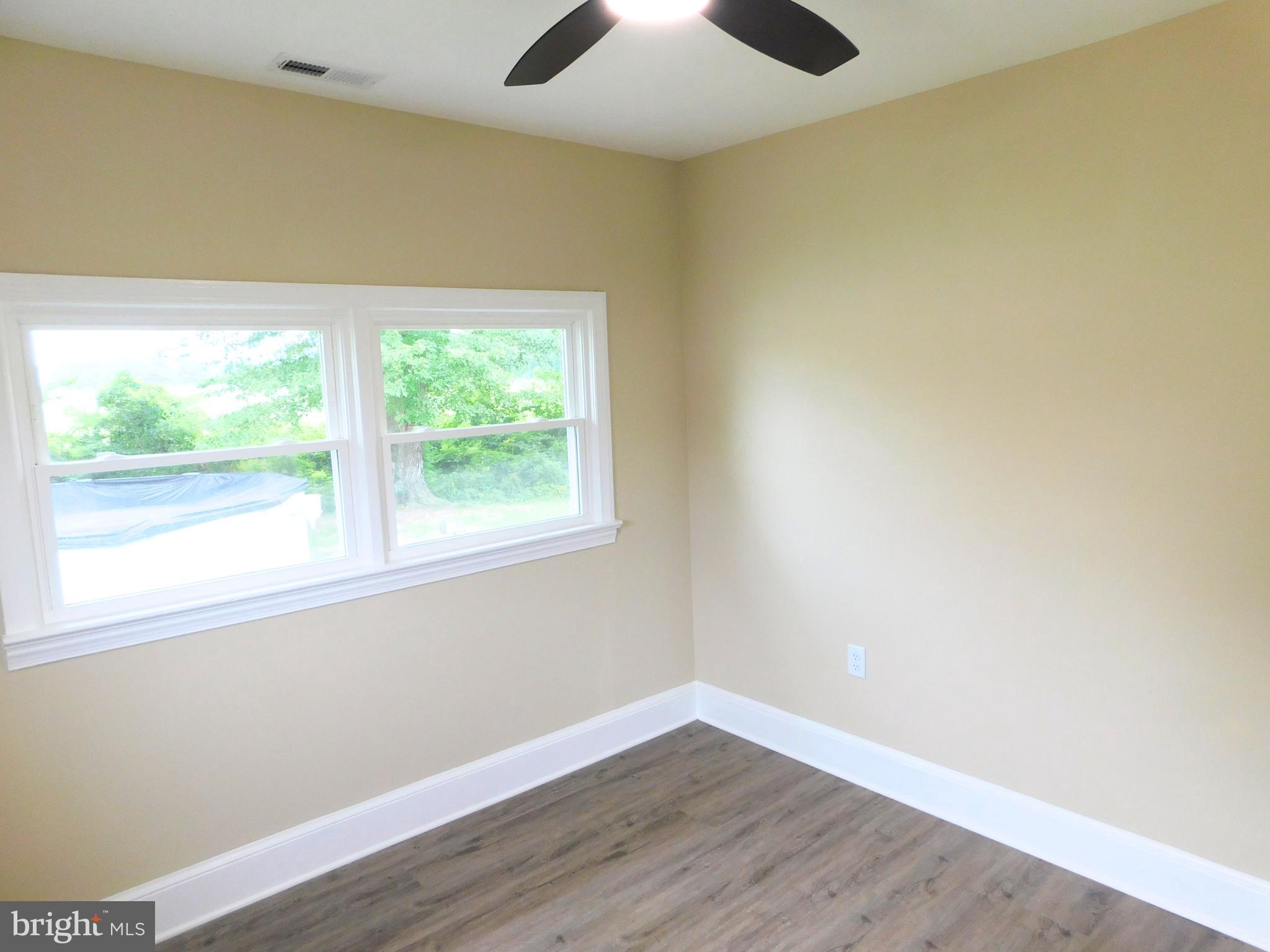 233 Hartly Road Hartly, DE 19953 - Photo 37 of 70 an empty room with wooden floor and windows