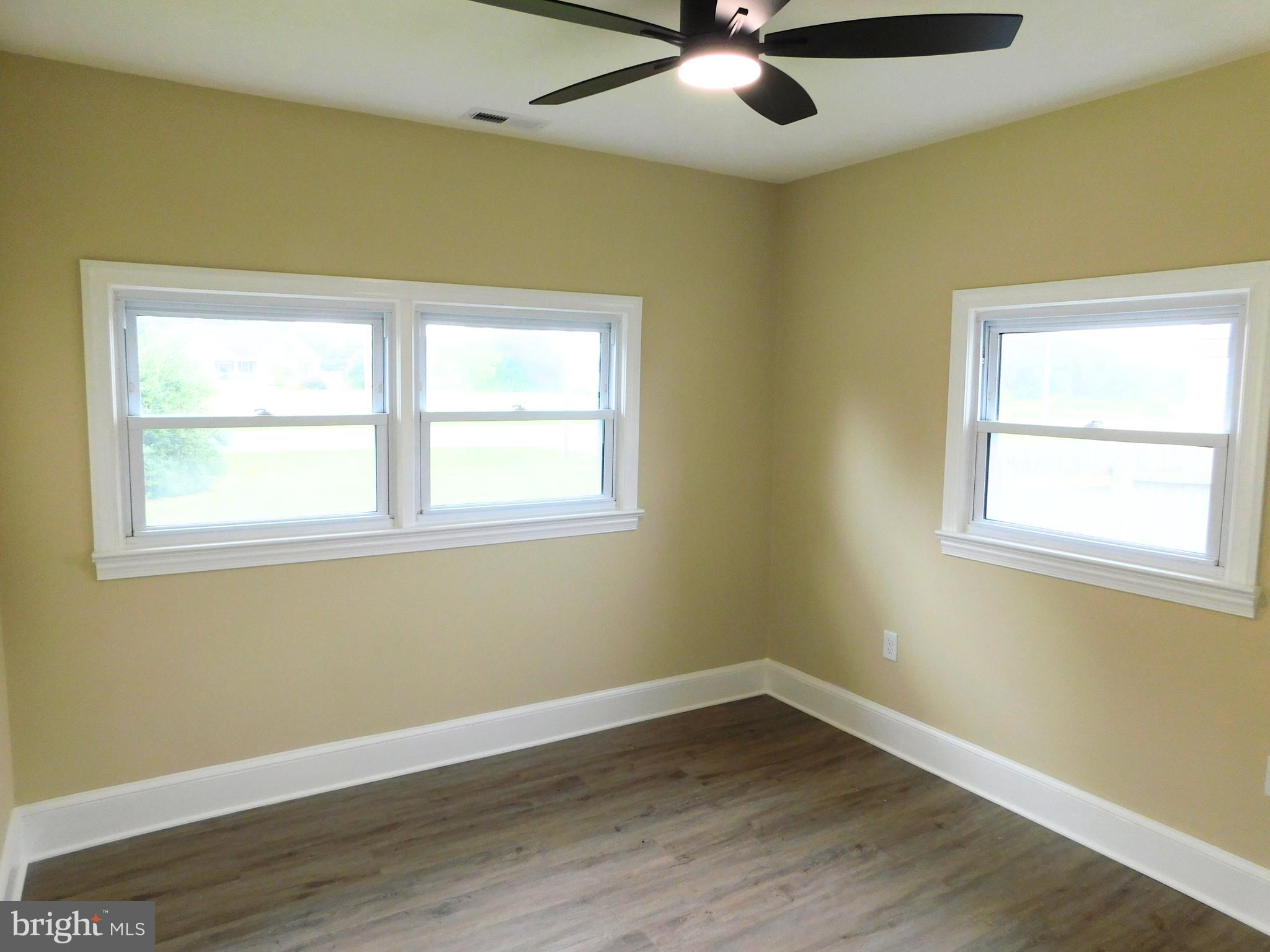 233 Hartly Road Hartly, DE 19953 - Photo 38 of 70 a view of an empty room with wooden floor and a window