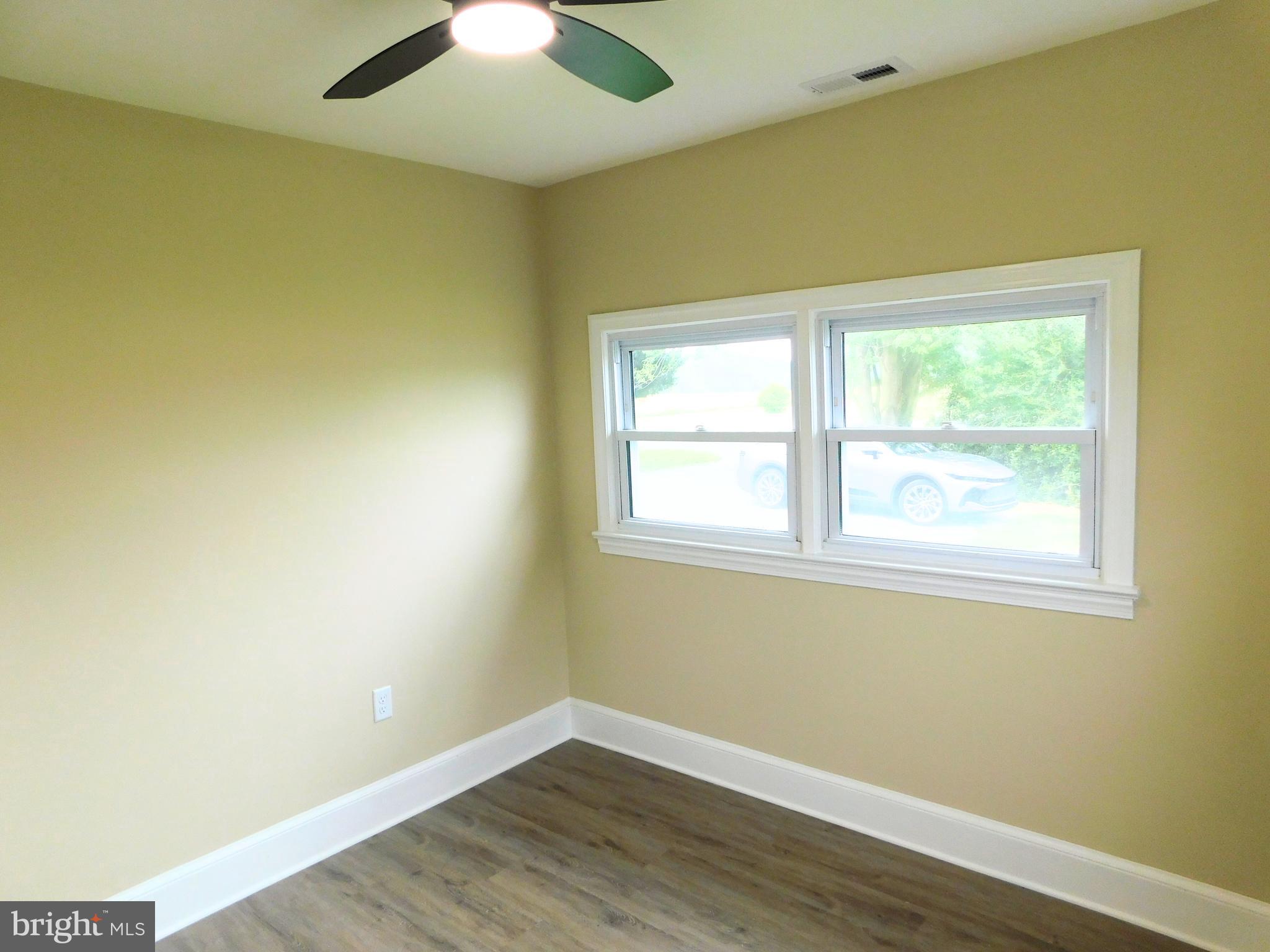 233 Hartly Road Hartly, DE 19953 - Photo 40 of 70 an empty room with a window and wooden floor