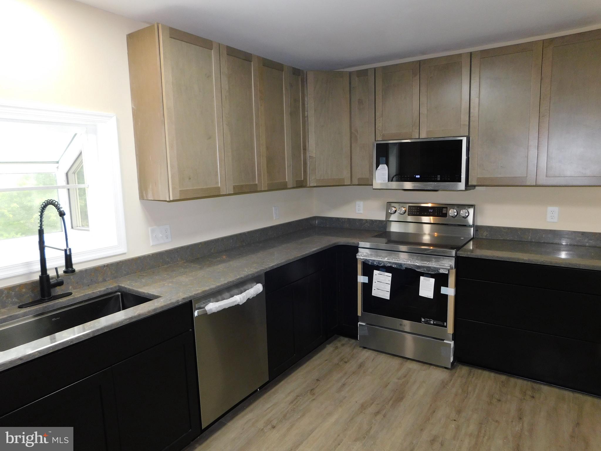 233 Hartly Road Hartly, DE 19953 - Photo 9 of 70 a kitchen with a sink and a stove top oven
