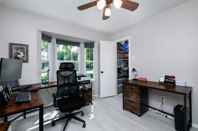 a living room with furniture a window and a flat screen tv