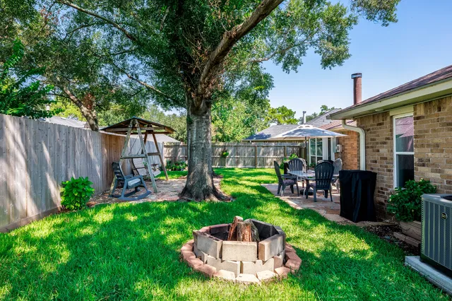 a view of a house with backyard porch and sitting area