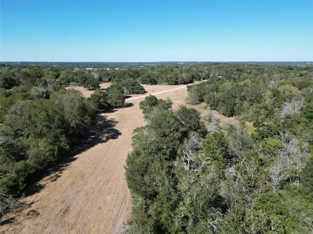 an aerial view of a houses with a yard