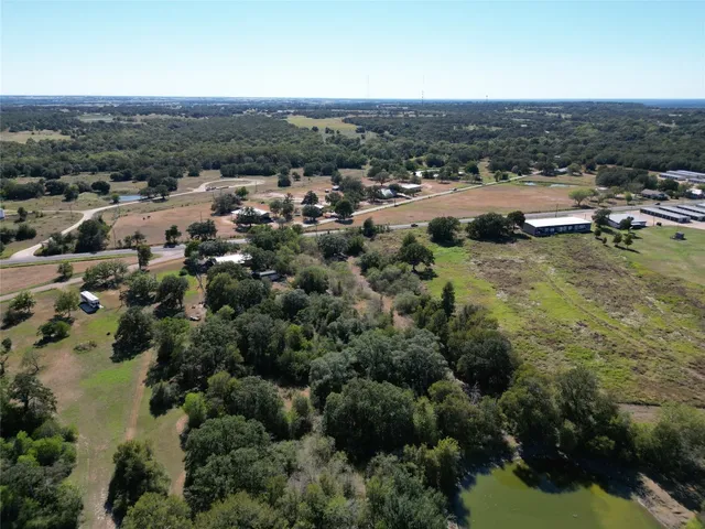 an aerial view of residential houses with city view