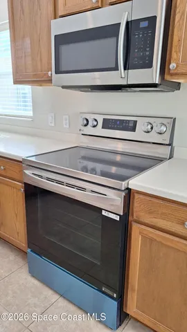 a stove top oven sitting inside of a kitchen
