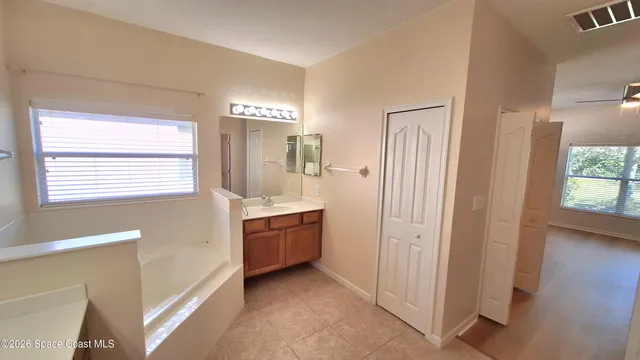 a view of an empty room with window and cabinet