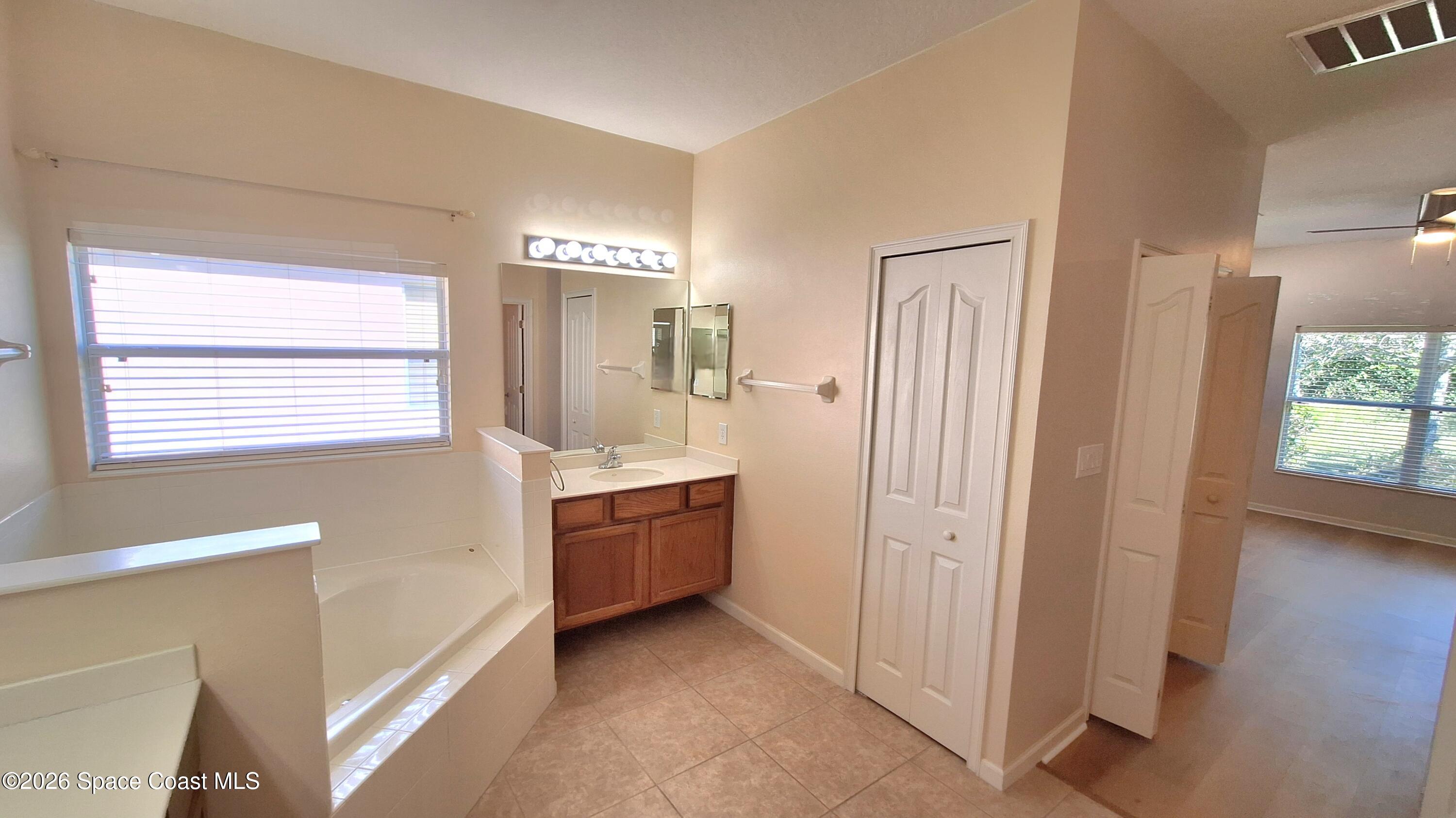 6921 Abbeyville Road Melbourne, FL 32940 - Photo 16 of 24 a view of an empty room with window and cabinet