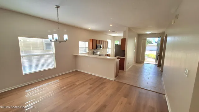 a view of a kitchen center island wooden floor and a window