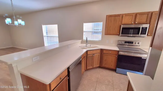 a kitchen with a sink a stove and microwave