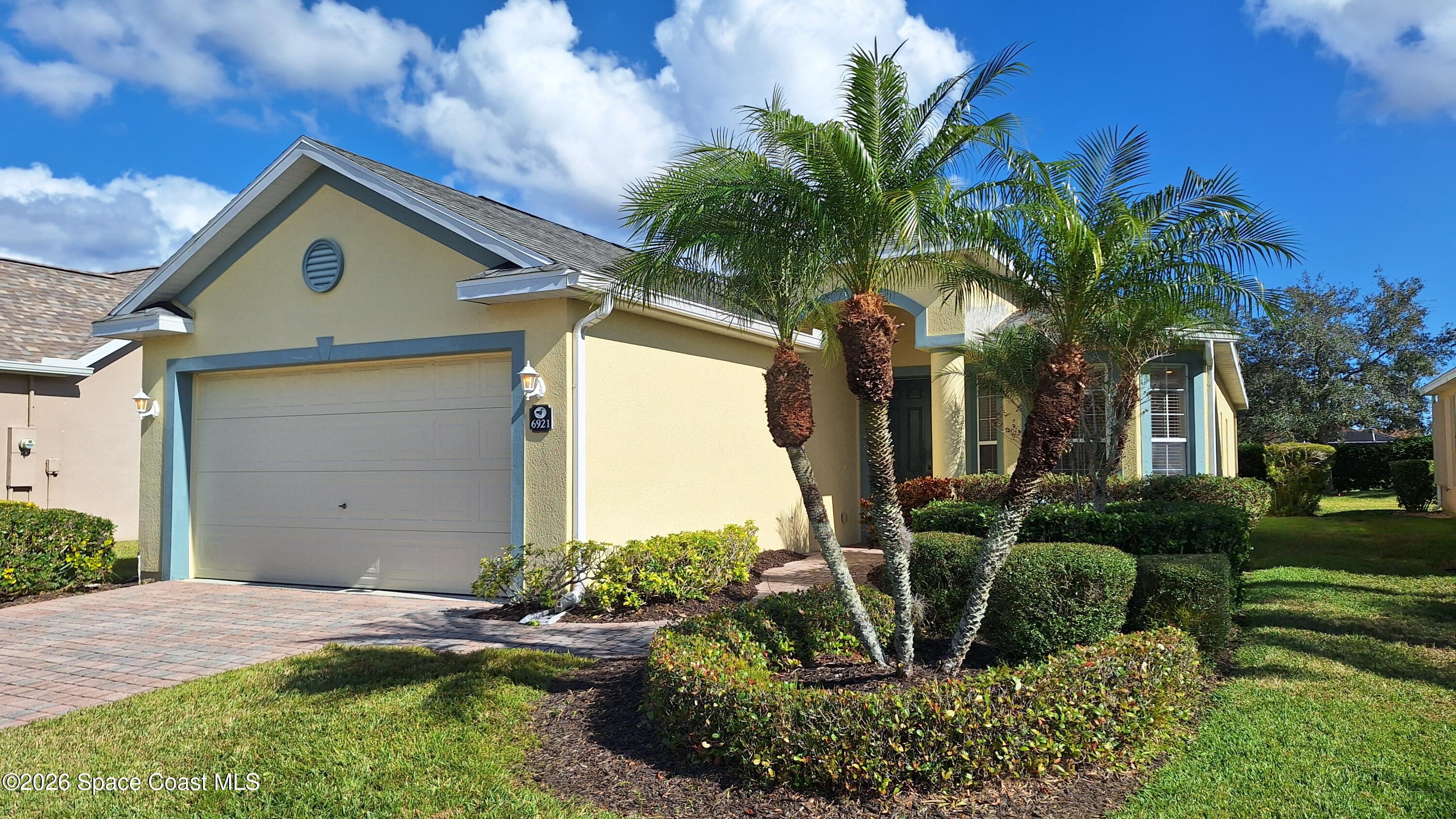6921 Abbeyville Road Melbourne, FL 32940 - Photo 2 of 24 a front view of a house with garden