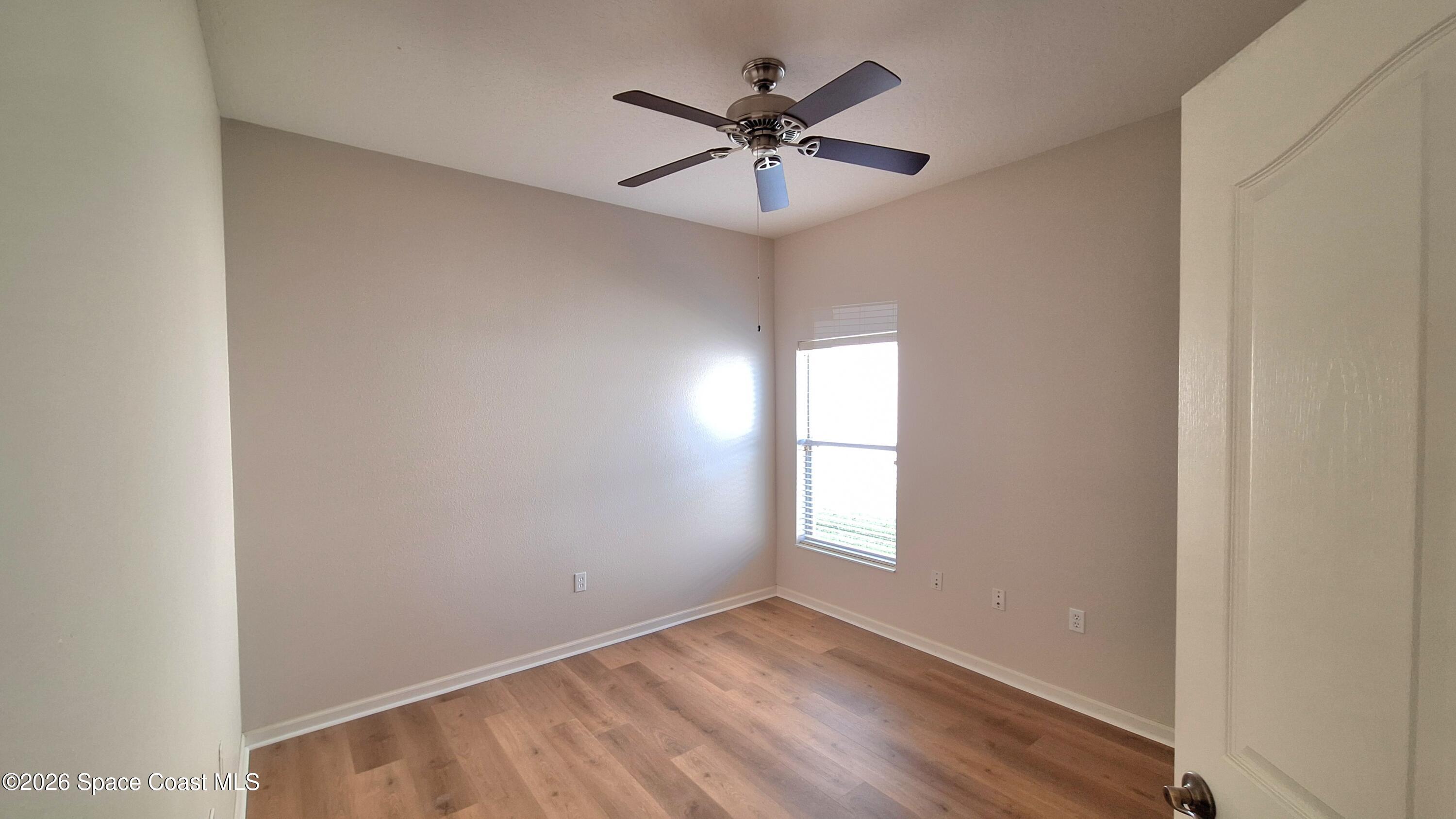 6921 Abbeyville Road Melbourne, FL 32940 - Photo 21 of 24 an empty room with windows and fan